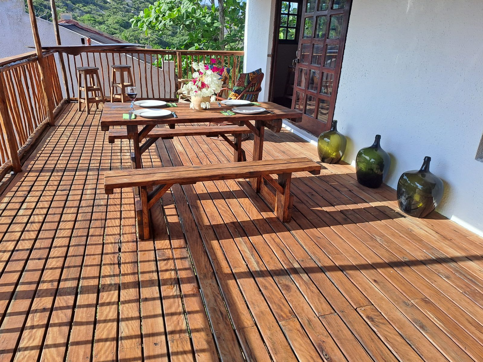 Long timber deck set for lunch, with views to the hills