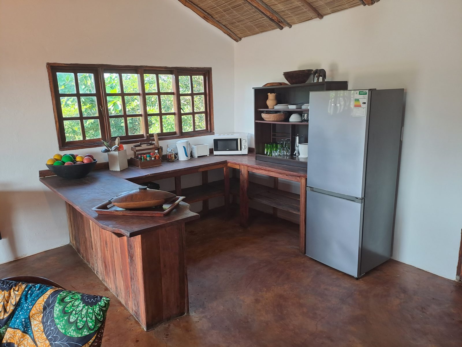 Open kitchen with hardwood counters and garden windows